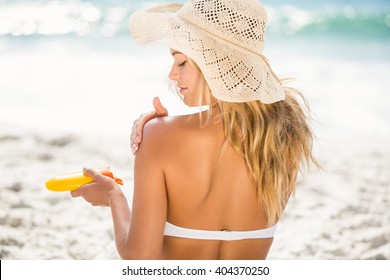 Woman Applying Sunscreen On A Sunny Day