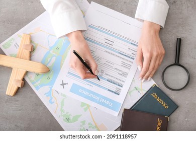 Woman Applying Travel Insurance Form In Office