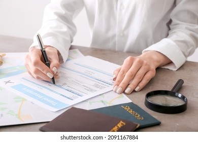 Woman Applying Travel Insurance Form In Office