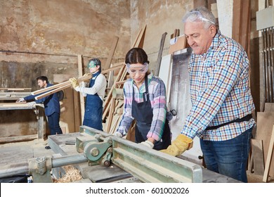 Woman as apprentice during carpentry lesson at workshop - Powered by Shutterstock