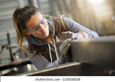 Woman Apprentice Training In Metalwork Workshop