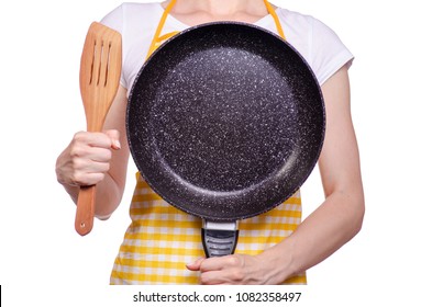 Woman In Apron In Hand Frying Pan And Kitchen Spatula On White Background Isolation