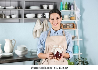 Woman In Apron Holding Jar With Jam On Vintage Kitchen