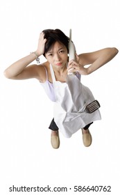 Woman In Apron Using Cordless Phone, Frowning