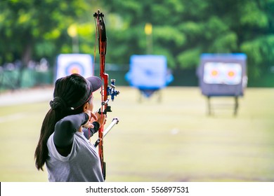 woman archer shooting with his bow