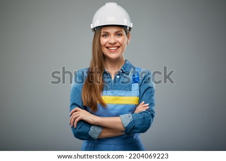 Woman architect or engineer in safety industrial helmet standing with arms crossed. Isolated female portrait.