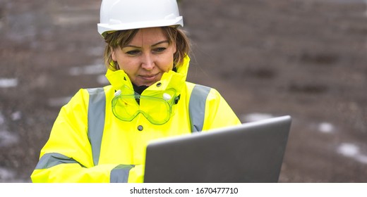 Woman Architect Inspecting Site. Woman Civil Engineer Close Up. Young Woman Using Laptop On Construction Site. Woman Engineer Developer Holding Laptop Working Confident Outdoors In Construction Site. 