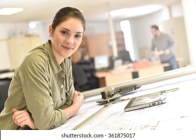 Woman Architect Working On Drawing Table In Office