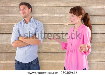 Woman arguing with uncaring man against wooden surface with planks