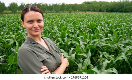 Woman With Arms Crossed In A Corn Field. The Woman Did A Good Job In Agriculture.