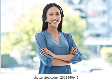Woman with arms crossed, portrait and callcenter, contact us with customer service agent in workplace with smile. CRM, communication and tech support, female consultant for help desk and mockup space