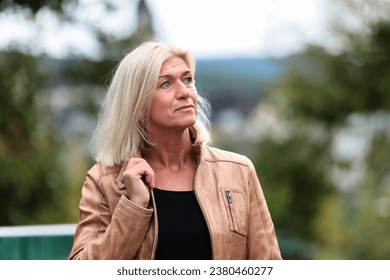 Woman around 50 years old in leather jacket, head portrait looking to the left.
 - Powered by Shutterstock