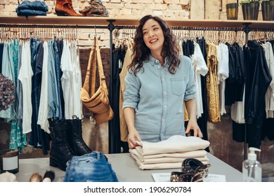 Woman Arranging Clothes On Table Store Stock Photo 1906290784 ...
