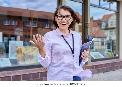 Woman Art Gallery Worker Standing Near Glass Showcase Of Outdoor Art Store