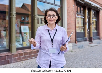 Woman Art Gallery Worker Standing Near Glass Showcase Of Outdoor Art Store