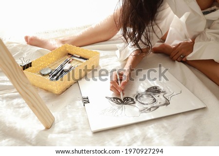 woman artist hands in white shirt drawing picture with pencil (woman lifestyle concept)