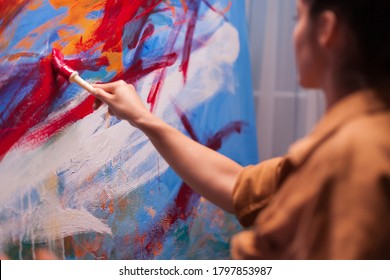 Woman Artist Holding Paint Brush On Large Canvas In Art Studio. Modern Artwork Paint On Canvas, Creative, Contemporary And Successful Fine Art Artist Drawing Masterpiece