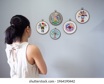 woman artist looking embroidery art abstract mind spiritual hand art contemporary artwork modern craft hobby in gallery exhibition museum, home wall decoration interior indoors selective focus