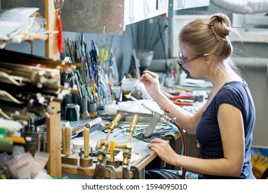 Woman Artist Making Glass Jewelry In Her Workshop, Unusual Hobby