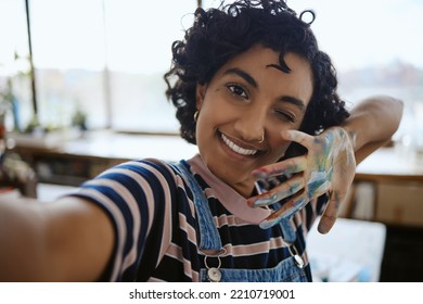 Woman Artist Taking Selfie, Painter In Her Art Workshop And Happy With A Hand Full Of Paint. Young, Indian Professional Creative Smile In Self Portrait, Having Fun Painting And Working.