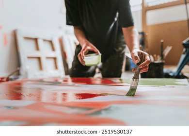 Woman artist working on her paint canvas in her studio , woman artist painting canvas in studio, young woman artist in art studio, woman painting on canvas - Powered by Shutterstock