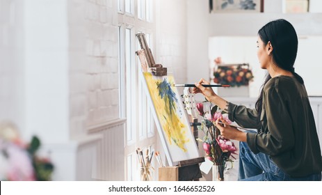 Woman Artist Works on Abstract acrylic painting in the art studio. - Powered by Shutterstock