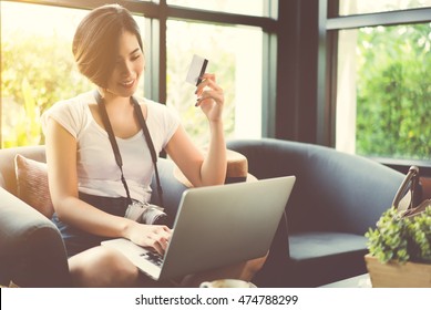 Woman Asian Travelers She Shopping Online Or In Flight. By Credit Card At A Coffee Shop