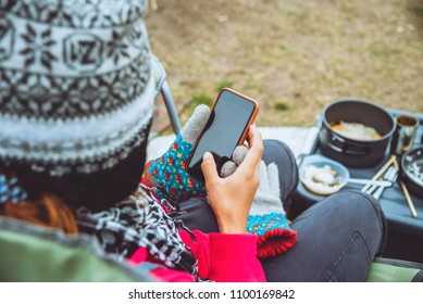 Woman Asians Travel Relax Camping In The Holiday. On The Moutain. Sitting On Chair Hands Holding Phone. Thailand