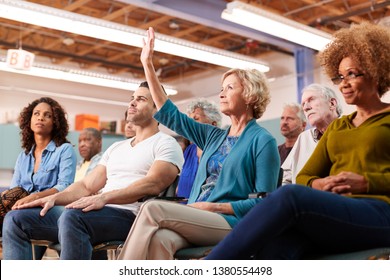 Woman Asking Question At Neighborhood Meeting In Community Center