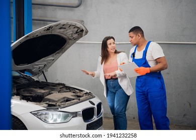 Woman asks mechanic to fix car engine