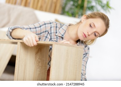 A Woman Assembling Furniture Alone