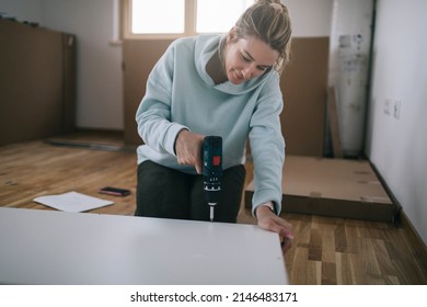 Woman Assembling Furniture At Home 