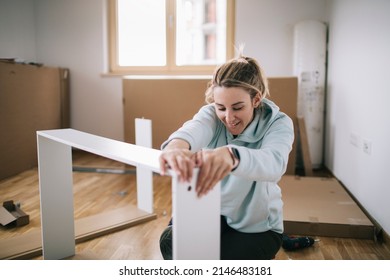 Woman Assembling Furniture At Home 