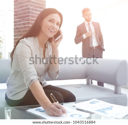 Woman assistant at the workplace in the office