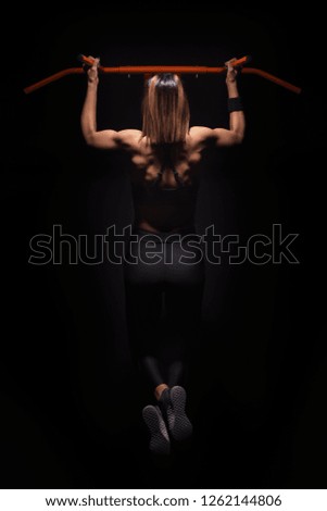 Similar – Image, Stock Photo Rear view portrait of one young middle age athletic woman at crossfit training, exercising with trx suspension fitness straps over dark background