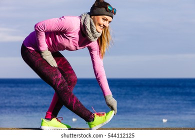 Woman Athlete Girl Training Wearing Warm Sporty Clothes Outside By Seaside In Cold Weather. Sports And Activities In Winter Or Autumn Time.