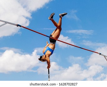 Woman Athlete Pole Vaulter In Pole Vault Competition Background Blue Sky