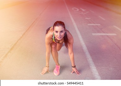 Woman Athlete In The Ready  Set  Go Position To Start Running. Success Concept