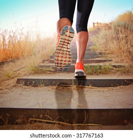  A Woman With An Athletic Pair Of Legs Going For A Jog Or Run During Sunrise Or Sunset Up Stairs In The Mountains - Healthy Lifestyle Concept For Urban Living 