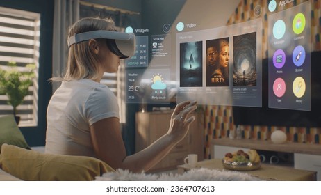 Woman in augmented reality headset chooses movie or TV show to watch at home. 3D graphics shows interface of streaming service app and widgets in user menu. VFX animation. Entertainment and lifestyle. - Powered by Shutterstock