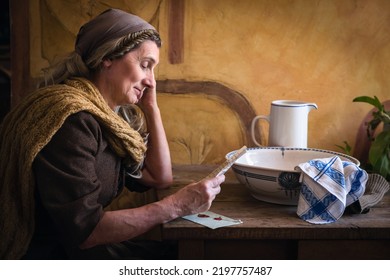 Woman in authentic peasant renaissance costume reading a letter
