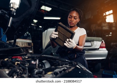 Woman Auto Mechanic Checking Air Filter And Repair Maintenance Auto Engine Is Problems At Car Repair Shop.