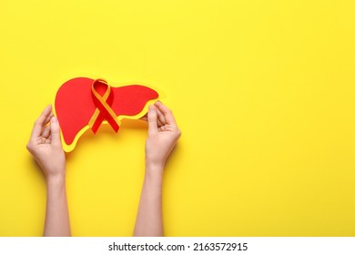 Woman With Awareness Ribbon And Paper Liver On Yellow Background. Hepatitis Concept