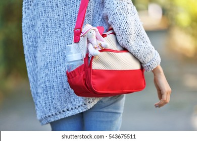 Woman With Baby Bag On Street