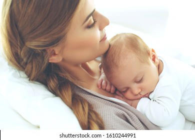 Woman With A Baby. Mom With A Small Child At Home.
