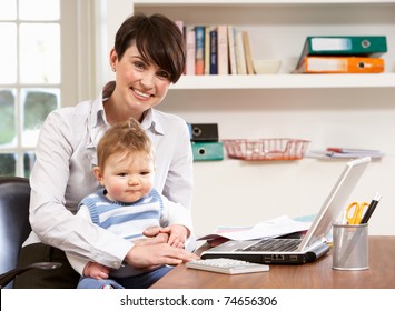 Woman With Baby Working From Home Using Laptop - Powered by Shutterstock