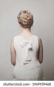 Woman Back And Blonde Curly Updo Hairstyle On White Background