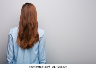 Woman Back With Long Hair Isolated On Gray Background.