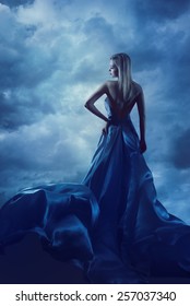 Woman Back Portrait In Evening Dress, Lady In Silk Gown, Cloth Flying Over Blue Sky, Night Clouds