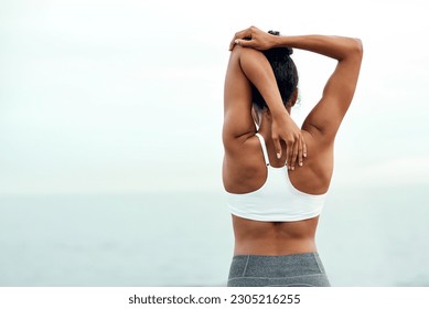 Woman, back stretching and outdoor for yoga, workout and training with mockup space. Wellness, nature and ocean with female person doing exercise for health and relax by the sea with stretch arms - Powered by Shutterstock